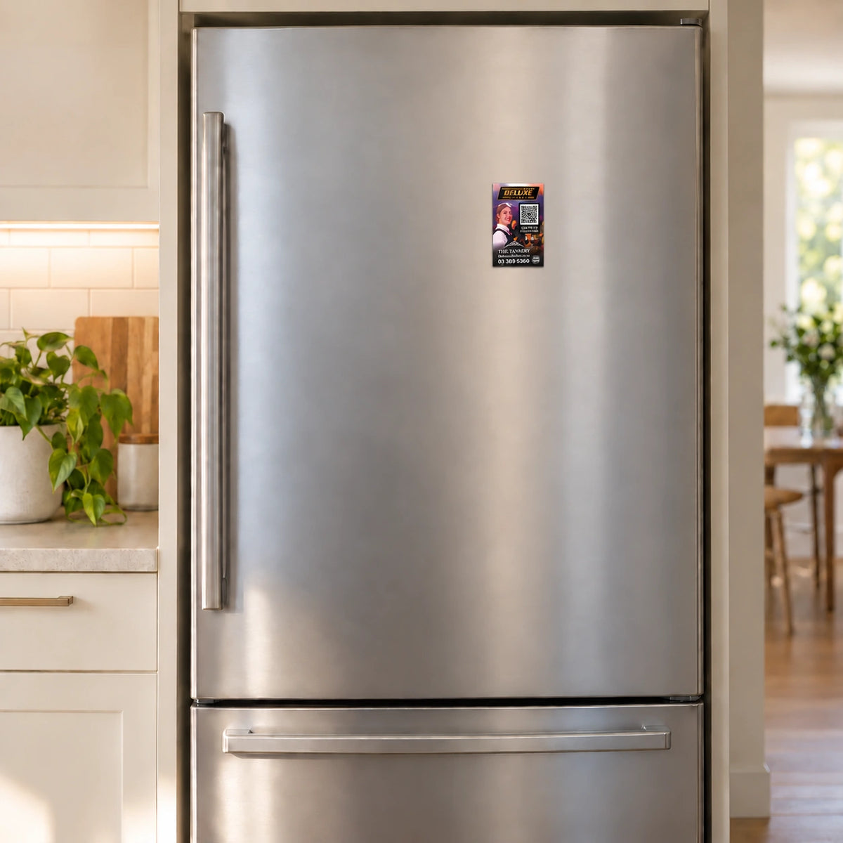 Illustrative Deluxe Cinemas fridge magnet shown at compact size on a kitchen refrigerator